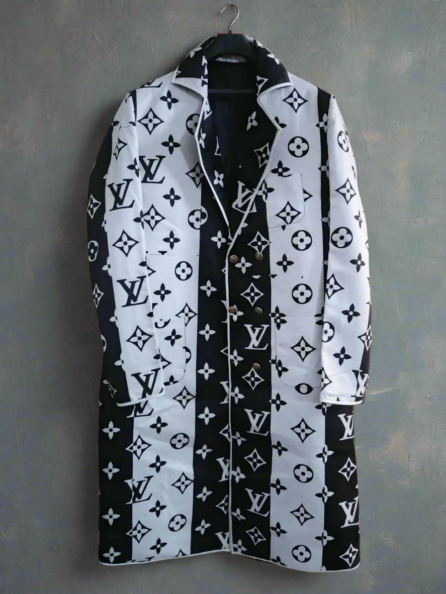 Black and white patterned mens long coat on a hanger against a wooden background