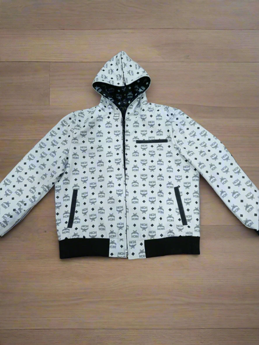 White jacket mcm leather jacket with black print on a wooden floor