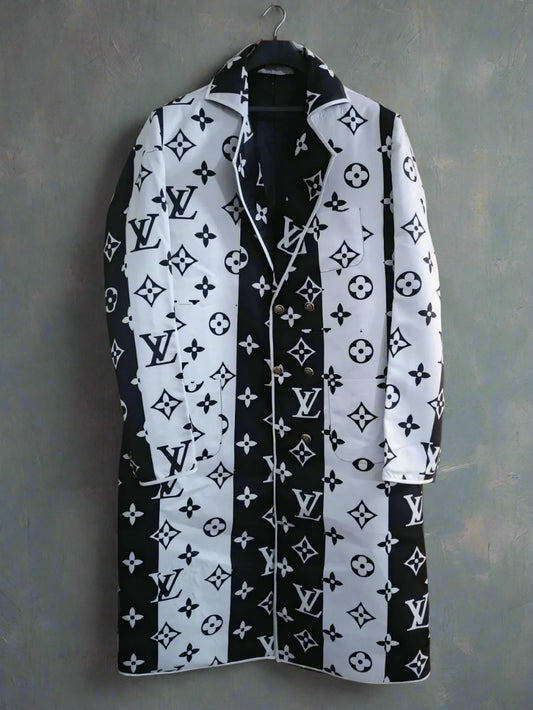 Black and white patterned mens long coat on a hanger against a wooden background